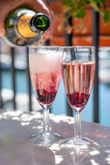 Summer party with sparkling rose champagne wine and sail boats haven of Port Grimaud on background, Provence, France
