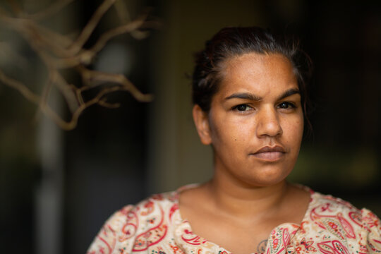 head and  shoulders of young woman looking out from veranda