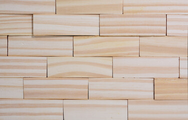 wall made of wooden cubes. use as background, background texture.
