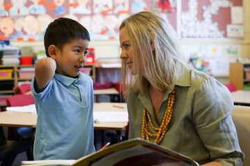 A primary school aged child speaking with his teacher