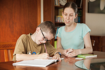 Teen girl teaching her younger brother another language
