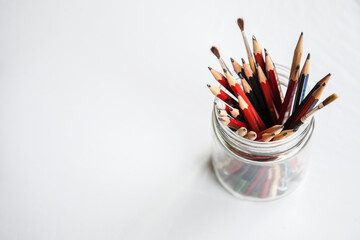 Graded graphite art pencils in jar on white