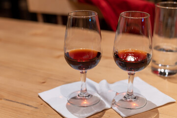 Professional tasting of different fortified dessert ruby, tawny port wines in glasses in porto cellars in Vila Nova de Gaia, Portugal
