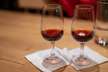 Professional tasting of different fortified dessert ruby, tawny port wines in glasses in porto cellars in Vila Nova de Gaia, Portugal