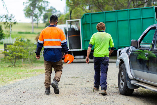 Two tradie blokes walking back to car after job is done