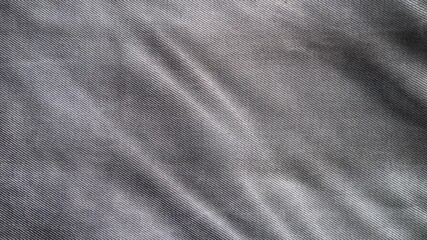 Macro shot of gray denim, jean. Modern dress textile, detailed fashion material.