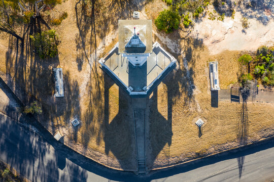 Aerial view over the top of a lookout tower on a hill top.