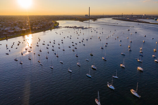Aerial view of lines of yachts anchored on a quiet bay at sunset