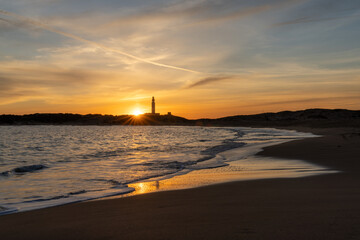 sunset on the Playa de Maria Sucia Beach with the Cape Trafalgar Lighthouse in the background