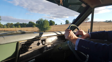 Man driving a classic car in the country