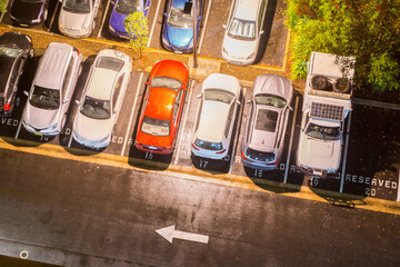Looking down onto the tops of cars in a carpark on a wet night