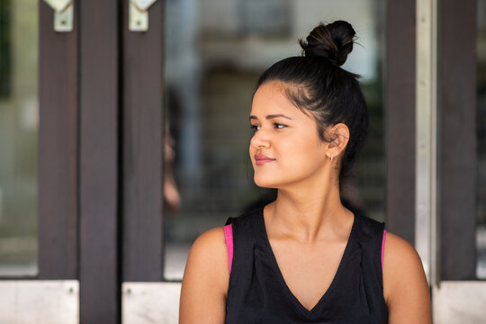 Young Woman, Casual With Hair In A Bun