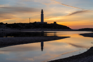 the Cape Trafalgar lighthouse after sunset with colorful evening sky