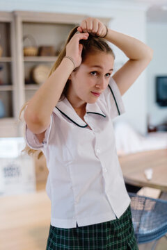 high school student doing hair in the morning