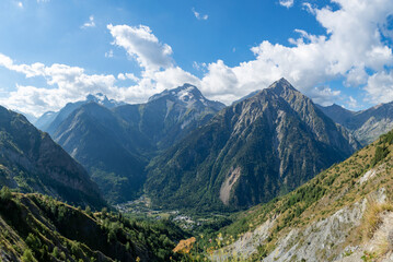 Hiking near ski station Les deux Alpes and view on Alpine mountains peaks in summer, Isere, France