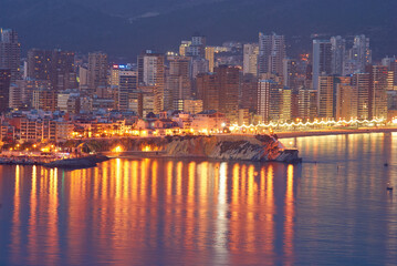 Fototapeta premium top view of the beach, buildings and illuminations in the evening at Playa de Levante and Playa de Poniente beach in Benidorm, Spain