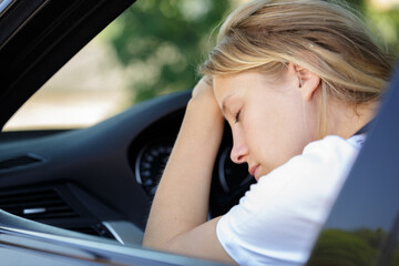 portrait of a woman sleeping in car