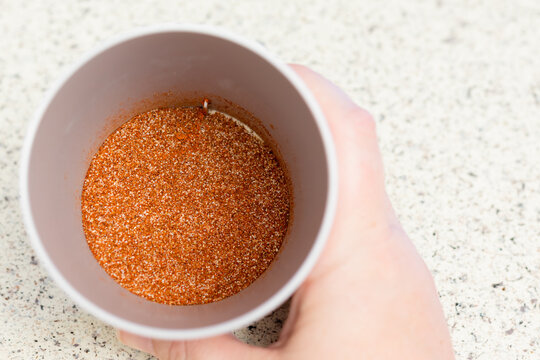 Homemade Taco Seasoning Inside Of A Shallow Gray Plastic Cup.