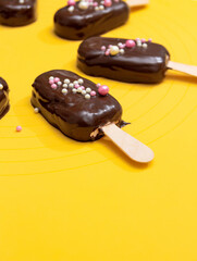 Marshmallow on a stick in the form of a popsicle covered with chocolate. Selective focus.