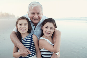 Happy multicultural grandparent with grandchildren on the beach