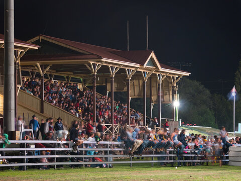 Spectators in a grandstand at night