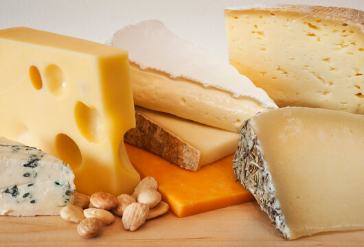 Various cheeses on chopping board