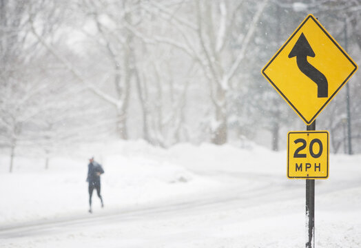 USA, New York City, speed limit and warning sign by snowy road