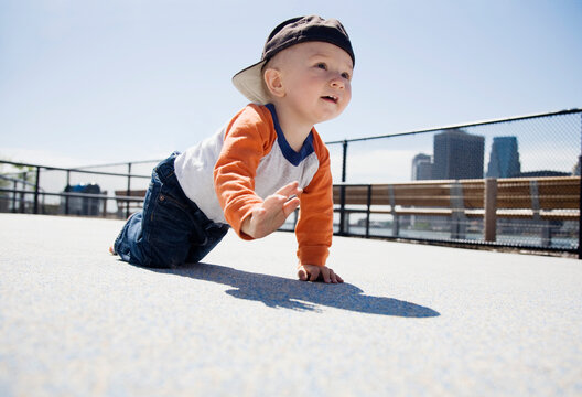 USA, New York City, Brooklyn, baby boy (0-1 years) crawling on sidewalk