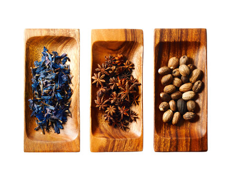 Studio shot of star anise, nutmeg and lavender on wooden trays