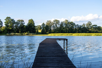 Fototapeta premium Wooden dock by the lake in summer.