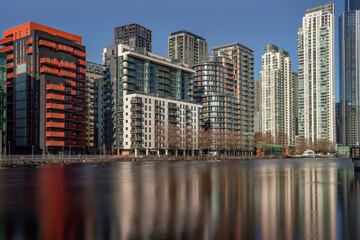 Fototapeta na wymiar Canary Wharf London UK housing skyscrapers and offices next to river