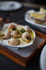 Snails in a creamy spinach sauce on the terrace of a seafood restaurant