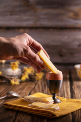 boiled egg in a silver eggcup with bread