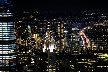 Scenic view of Manhattan chrysler building and skyscrapers at night - obrazy, fototapety, plakaty