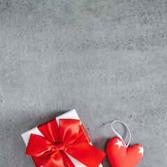Valentine's Day concept. gift, valentines, red hearts on gray stone background. Flat lay, top view, copy space, square