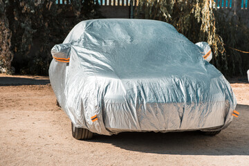 The car is in the parking with auto cover from the sun. Protection from heating the car.