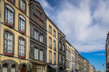 Obraz premium typical facades built with volcanic stones in the clock tower street (Rue de l'horloge), in Riom, a small town in Auvergne (France)
