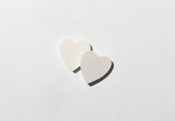 White hearts on the center of white paper background. Valentine Day minimalistic concept