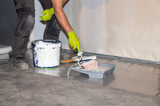 Close up view of male worker carrying out painting work. Construction concept.