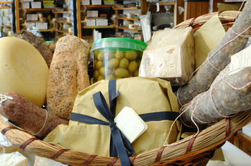 basket with different kinds of salami and cheese from Marche region as ciauscolo, lonza, pecorino...