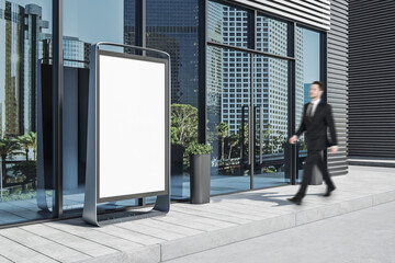 Businessman walking near empty vertical white rectangular stopper