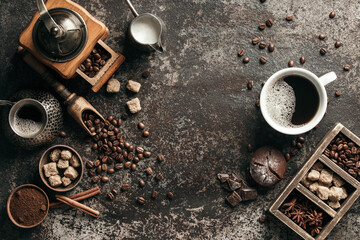 Coffee cup with coffee grinder and coffee beans on dark textured background. - obrazy, fototapety, plakaty