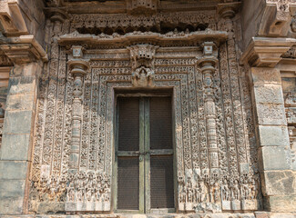 Lakkundi, Karnataka, India - November 6, 2013: Kasivisvesvara Temple. Brown stone locked side entrance to sanctum with entensively decorated door frame.