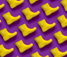 Modern pattern of yellow rain boots on purple background