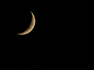 Obraz na płótnie Canvas The crescent moon shot against the night sky.