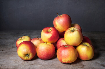 Ripe red-yellow apples on a wooden table. Whole apple tree fruit tree. Fruit tree harvest cathedral.