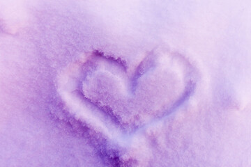 Heart silhouette close-up on the snow, drawn with your finger. Romantic colorful picture, separation and parting love and other emotions. Frost, purple background