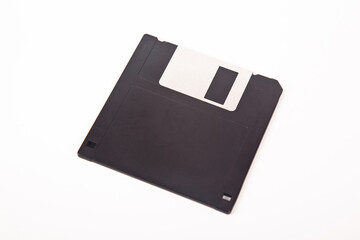 Old computer and data storage technology, black magnetic floppy disk 3½ inches, isolated on white...