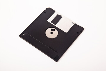 Old computer and data storage technology, black magnetic floppy disk 3½ inches, isolated on white...