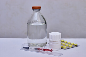 Syringe, bottle and pills. Preventive vaccination of people. Treatment of disease.